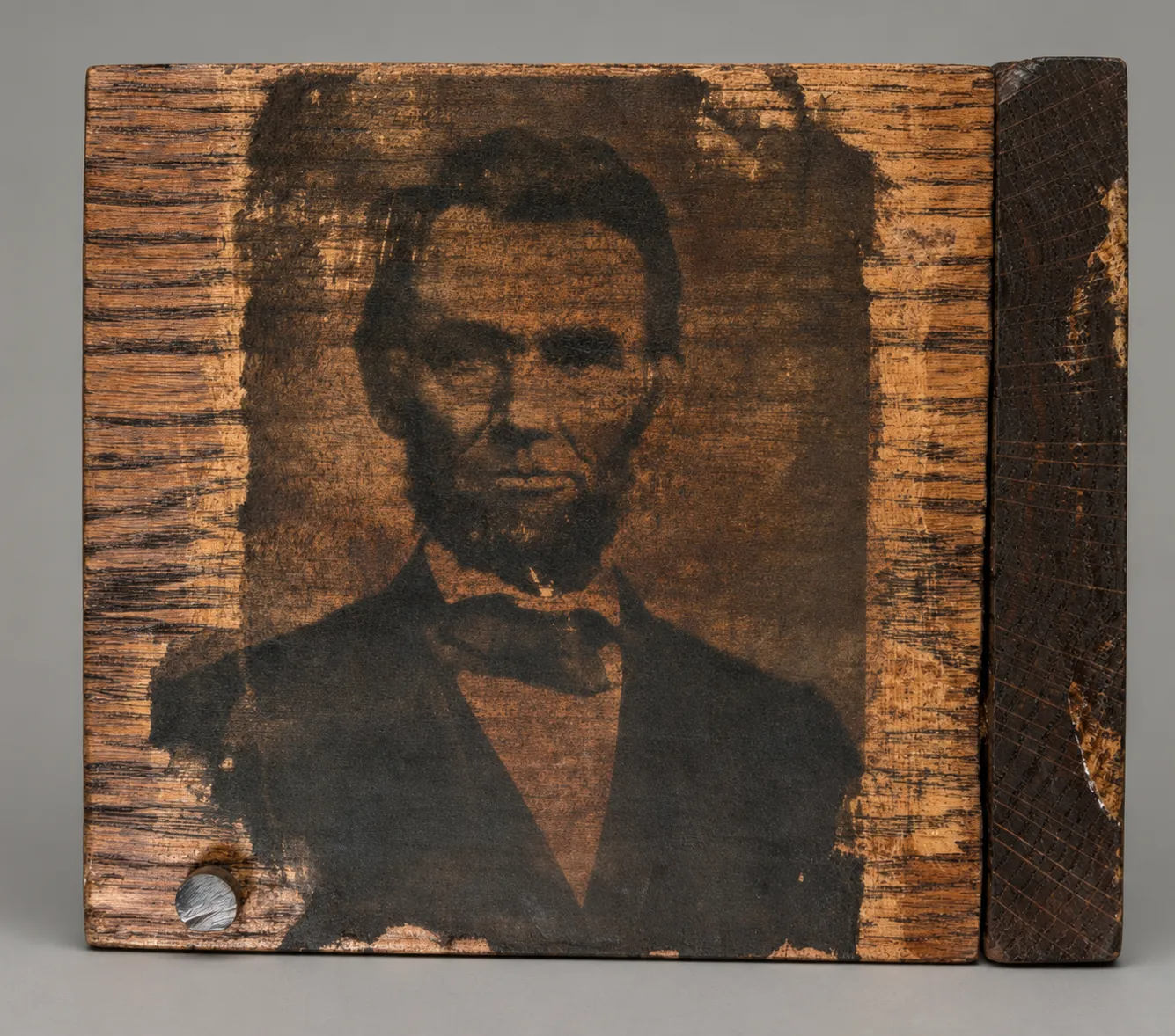 Lincoln, burned portrait on wood grain